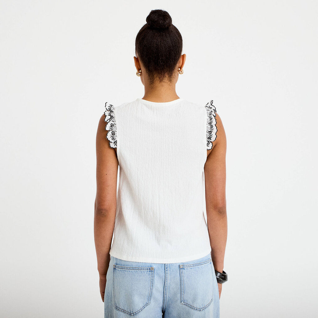 Blouse décolleté sans manches brodée noir femme